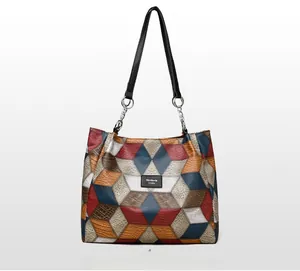 Detail of color-block tote bag with lychee texture and geometric pattern design