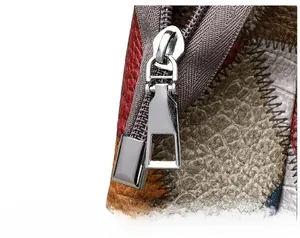 Macro shot of colorful textured leather panels and polished silver zipper slider detail