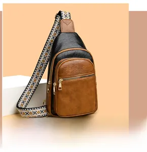 Detail of contrast leather chest bag with multi-zipper layers and woven ethnic strap