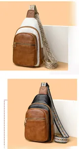 Detail of vintage multi-pocket crossbody bag with ethnic embroidered strap and leather texture