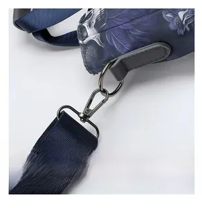Close-up of gunmetal swivel hook and durable nylon strap on floral skull tote bag