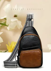Detail of lychee textured PU leather shoulder bag with woven strap and gold zippers