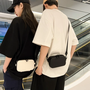 Fashionable hard shell crossbody bags in black and white with textured diagonal pattern