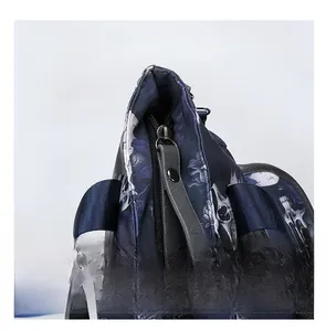Detail of smooth metal zipper and skull print pattern on durable nylon tote bag