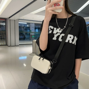Modern white hard shell crossbody bag with wave texture and adjustable black shoulder strap