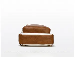 Detailed bottom view of vintage shoulder bag with contrast color and metal ring buckle