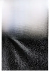 Detailed macro view of black pebbled leather texture with water-resistant surface