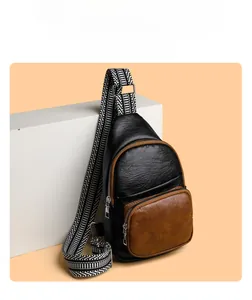 Close-up of retro crossbody bag with lychee grain leather and jacquard woven strap