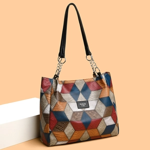 Minimalist multi-color patchwork tote bag with geometric leather patterns and chain handles