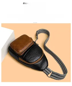 Detail view of a vintage crossbody bag with brown pocket and patterned fabric strap