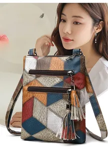 Macro detail of retro PU leather crossbody bag featuring geometric patchwork and tassels