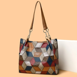 Large tote bag with colorful patchwork pattern and embossed crocodile texture straps