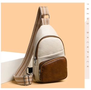 Detail of cream PU leather chest bag with brown zip pocket and woven strap