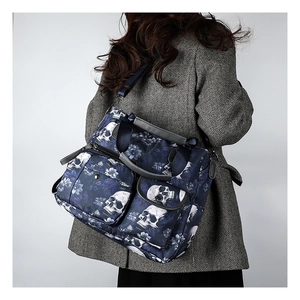 Detail of gothic skull print tote bag with multiple pockets on grey suit model