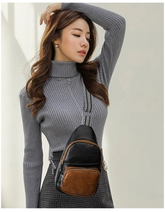 Retro multi-zippered crossbody chest bag with striped strap on a model outfit