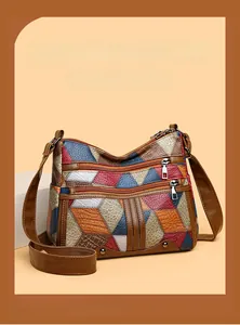 Detailed view of colorful patchwork faux leather with litchi texture and zip pockets