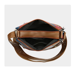 Detail view of the multi-compartment interior and colorful patchwork leather of the bag