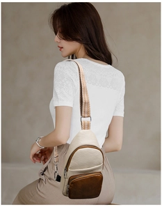 Close-up of a vintage retro crossbody bag with beige and brown leather patchwork design