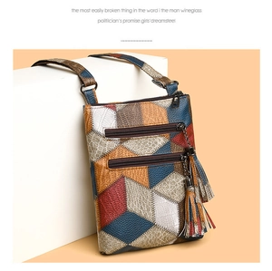 Detailed view of colorful patchwork leather texture and tassel zippers on the shoulder bag