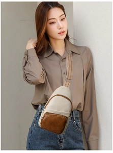 Detail of cross-body chest bag featuring beige PU leather and geometric jacquard strap