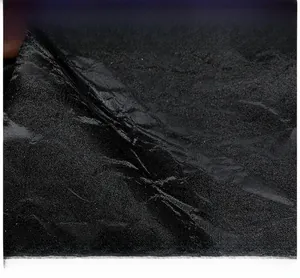 Macro view showing the soft texture and irregular grain of the black knitted tote bag fabric