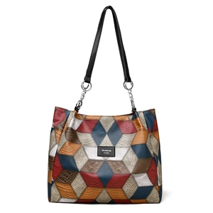 Large geometric patchwork tote bag with multi-color pattern and chain shoulder straps