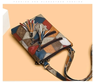 Detail of colorful patchwork PU leather crossbody bag with dual zippers and tassels
