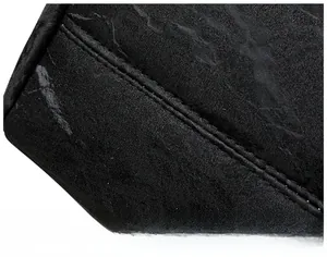 Macro shot of precise double stitching on black leather tote bag with marble texture
