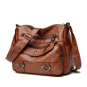 Brown vintage soft leather crossbody bag with multiple zip pockets and heart details