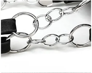 Detailed macro view of multi-layer electroplated metal chain strap on a black tote bag