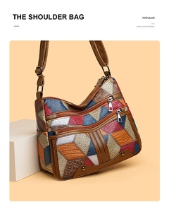 Detail of color-block patchwork leather showing multi-pockets and textured finish