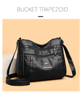 Close-up of black PU leather crossbody bag with multiple zippers and golden kangaroo logo