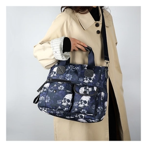 Detail of gothic floral skull print tote bag on model showing large capacity and pockets