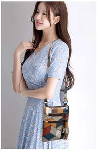 Detail of multi-pocket crossbody bag with 3D geometric pattern and tassel pendant