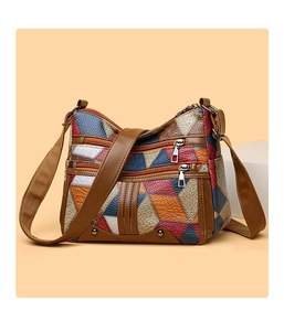Close-up of a multi-color geometric patchwork leather handbag with premium stitching