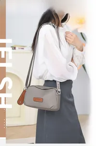 Close-up of JIELSHI grey waterproof oxford shoulder bag with logo detail and wide strap