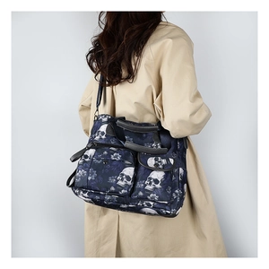 Detail of navy blue skull tote bag with multiple pockets and detachable shoulder strap