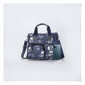 Size comparison of skull print tote bag with a smartphone to show storage capacity