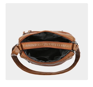 Detailed interior of caramel PU leather bag with three functional zipper compartments