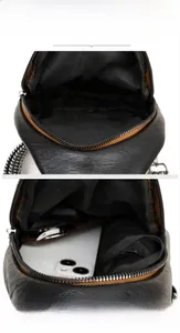 Detail view of the black textured crossbody bag interior showing space for phone and umbrella
