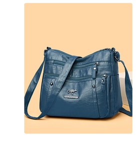 Detail of navy PU leather bag with lychee texture and silver kangaroo logo hardware