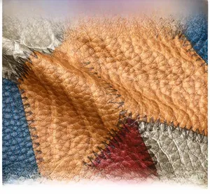 Macro shot of colorful pebbled PU leather patchwork with durable zigzag stitching detail