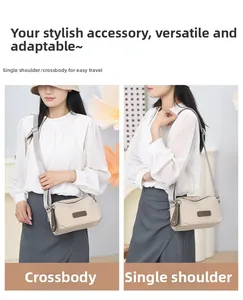 Detail view of beige nylon crossbody bag showing adjustable strap and brand logo