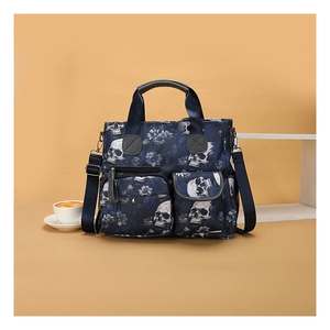 Close-up of skull print tote bag with dual front pockets and adjustable strap