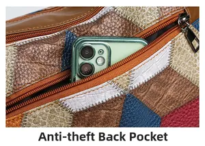 Detail of anti-theft back pocket on contrast leather bag with embossed snake pattern