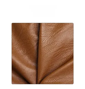 Close-up of soft brown PU leather texture and premium natural grain of the shoulder bag