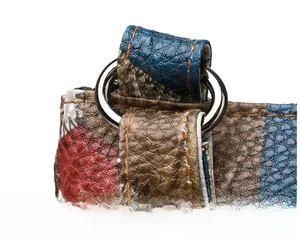 Detailed macro view of litchi grain PU leather stitching and metal strap rings