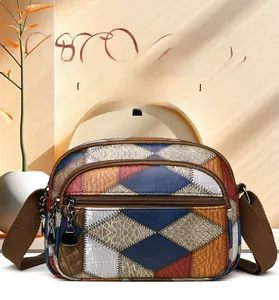 Detail of vintage patchwork crossbody bag with multi-layer zippers and textured panels