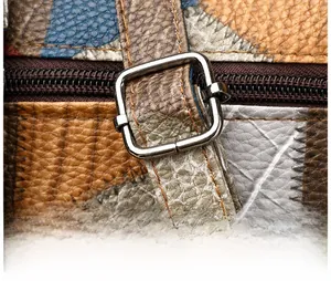 Detail of adjustable strap with silver buckle on color-block pebbled leather shoulder bag