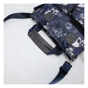 Detail of skull and floral print tote bag with reinforced handles and sturdy nylon fabric
